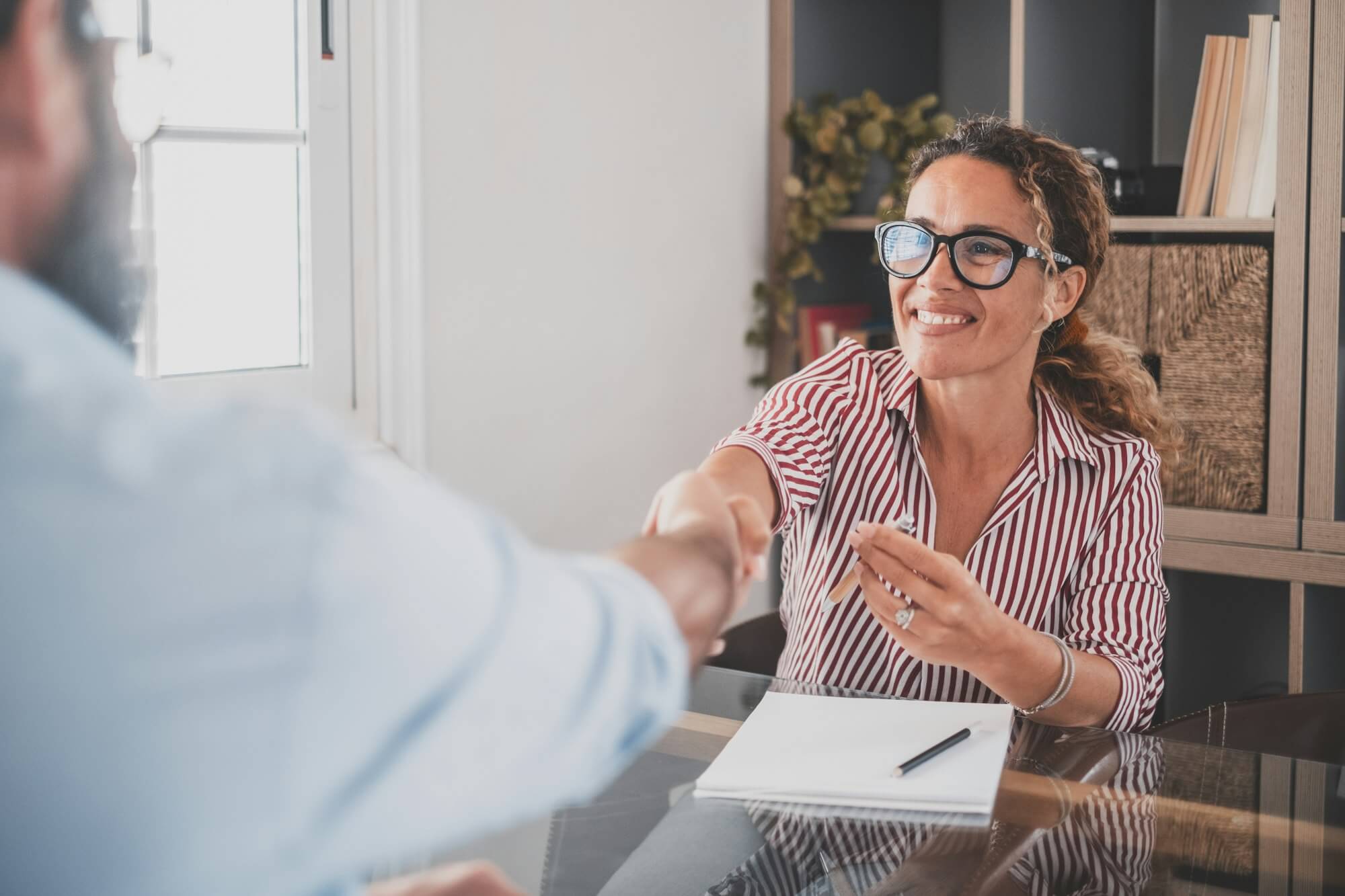 smiling-caucasian-female-hr-manager-handshake-hire-male-candidate-at-job-interview.jpg